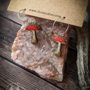 Connect to the spirit of the Fly Agaric with these Fly Agaric by Fen & Co. Fly Agaric is the plant of Spirit Flight, Poison, Witchcraft and the Otherworld.  This necklace has been upcycled from restored antique mushroom images, printed on to 4mm thick sustainably grown Birch Wood. Each necklace takes three days to complete. Each piece has two coats of varnish for protection- but should be removed before swimming and baths. The backs of the earrings are carefully painted black with a waterproof artistic paint and finished by hand with a luxurious gloss sealant.